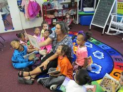 Woman reading a book to kids in an after school program