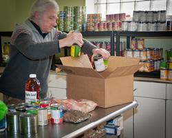 Volunteer stocking a food pantry